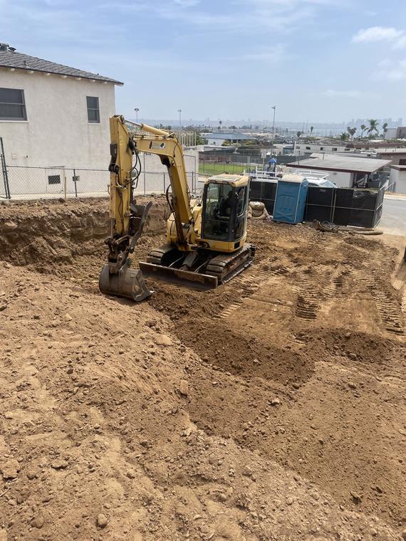 Excavator digging on a lot